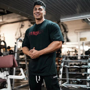 Black oversized t-shirt with red Vanquish graphic print and crew neck.