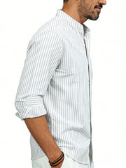 Men's white cotton blend long sleeve shirt with subtle pinstripes and buttoned collar.
