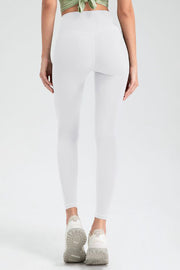 White high rise leggings with a seamless back detail and athletic shoes.
