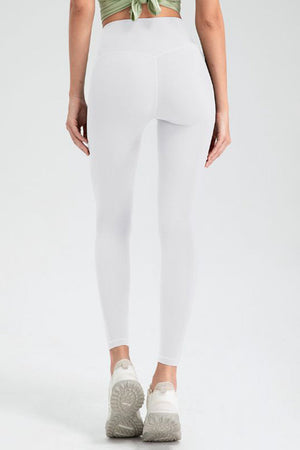 White high rise leggings with a seamless back detail and athletic shoes.