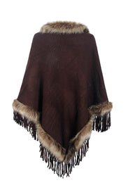 Chocolate knit poncho with faux fur trim and fringe detail.