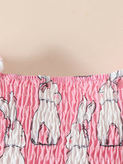 Pink baby dress with smocked bodice and bunny print, includes matching headband.