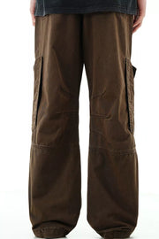 Brown cargo pants with snap pockets and reinforced knees.