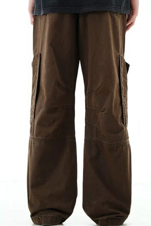 Brown cargo pants with snap pockets and reinforced knees.