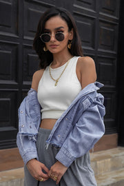 Light wash denim trucker jacket with raw hem and distressed details.