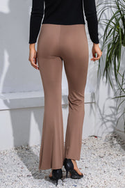 Camel flare leggings with a sculpted fit, styled with a black top and heels.
