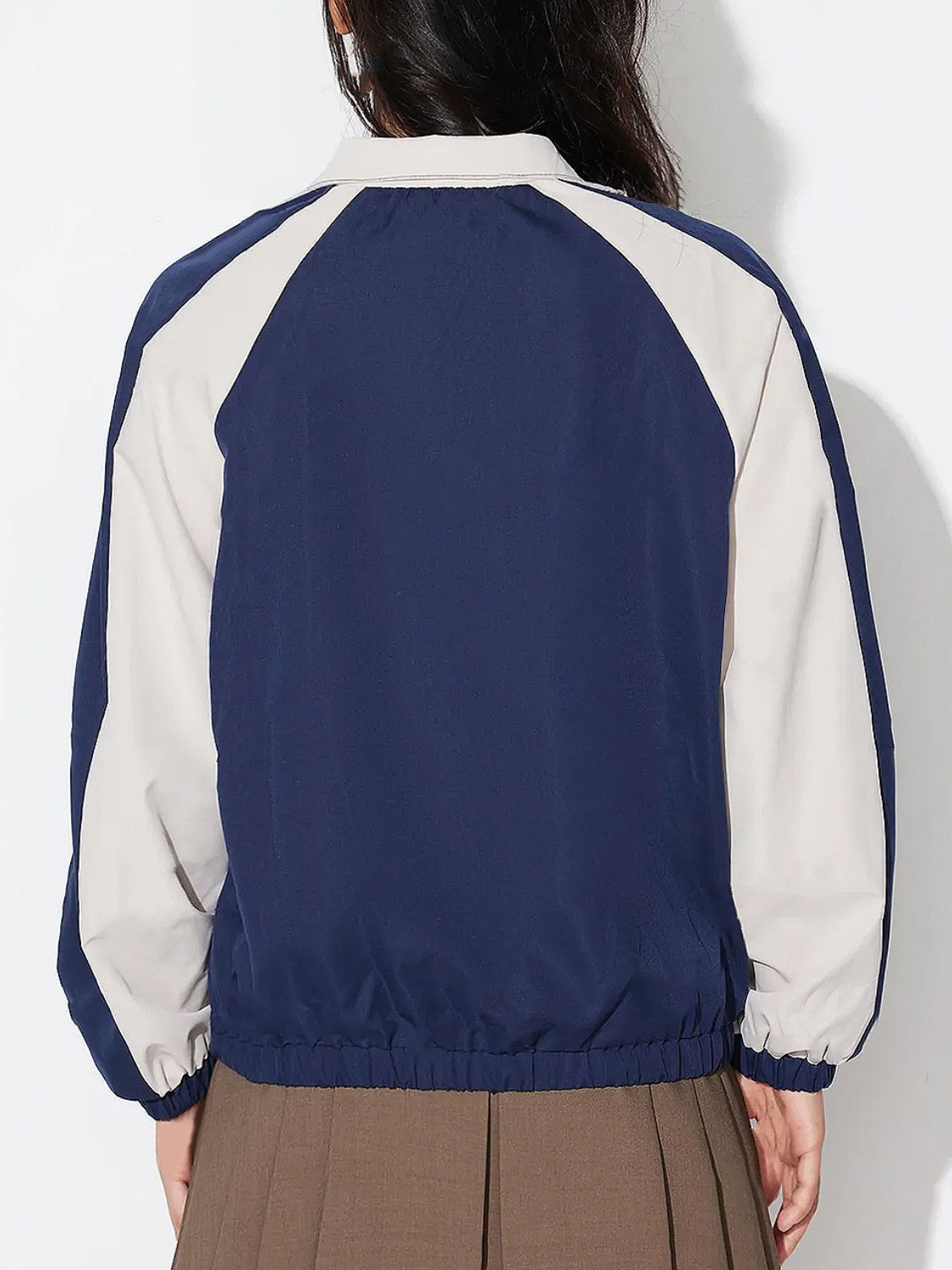 Colorblock raglan sleeve bomber jacket in dark blue with light beige accents.