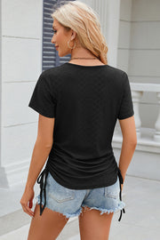 Black perforated tee with gathered sides and drawstring detail