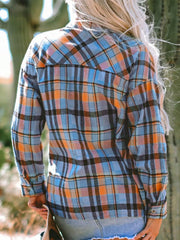 Oversized plaid shacket in sky blue, orange, and black with a relaxed fit.