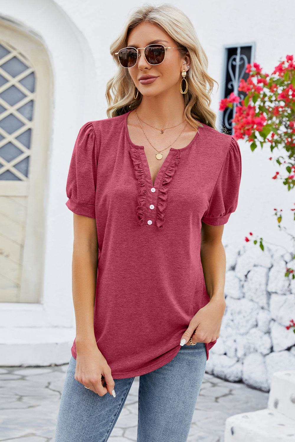 Watermelon pink tee with ruffled placket and puff sleeves.