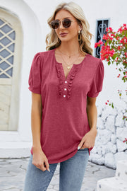 Watermelon pink tee with ruffled placket and puff sleeves.