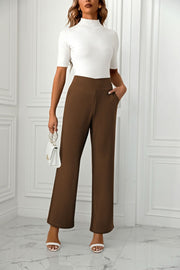 Brown wide-leg trousers with pockets and a sculpted waist.