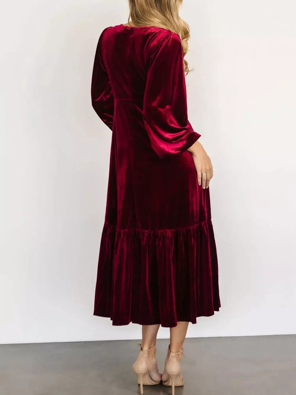 Burgundy velvet midi dress with tiered skirt and bell sleeves.