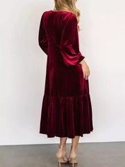 Burgundy velvet midi dress with tiered skirt and bell sleeves.