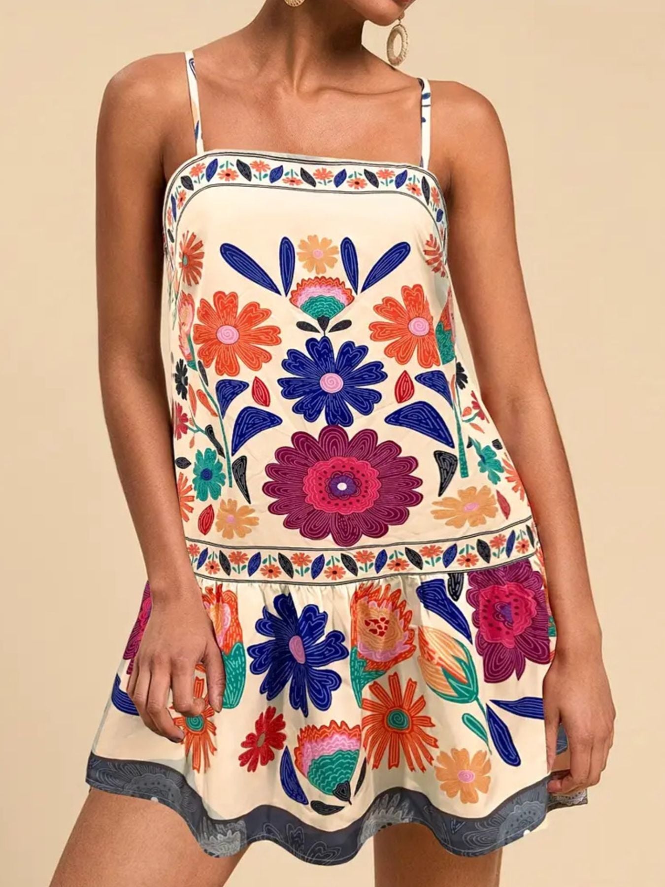Beige mini dress with a vibrant floral print, square neckline, and spaghetti straps.