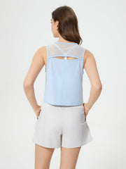 Light blue cropped active tank with mesh back detail and cutout.