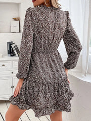 Ruffled tie neck floral mini dress in dark brown with long sleeves and tiered hem.