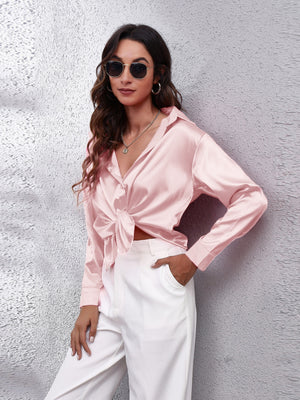 Blush pink silken button-down shirt with a tie front and long sleeves.