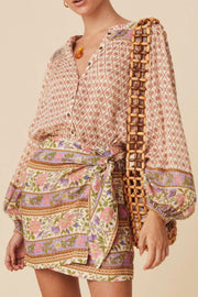 Bohemian print blouson sleeve top with button front and floral pattern.