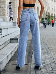 Ripped high-waisted denim jeans with a relaxed fit and button closure.