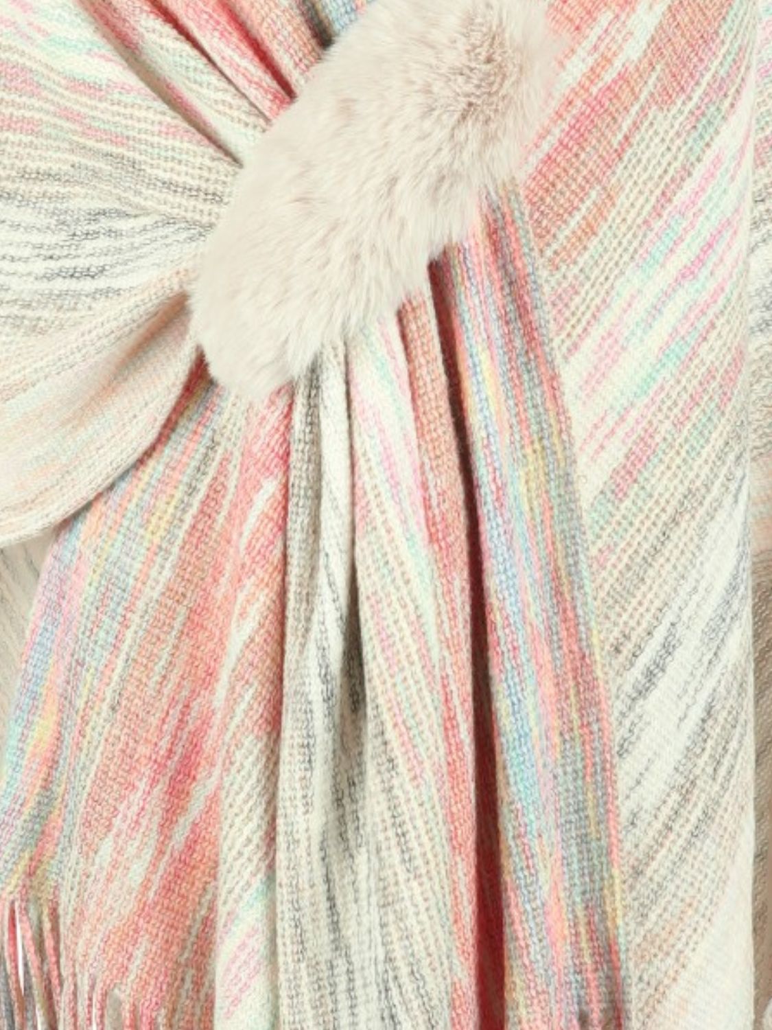 Knit wrap coat with pastel stripes and a faux fur pom-pom detail.