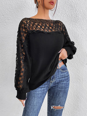Black acrylic sweater with lace inset balloon sleeves and boatneck.
