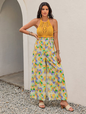 Gold crochet halter jumpsuit with a vibrant floral print and wide palazzo legs.