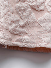 Textured floral peplum tank top in dusty pink with a boat neckline.