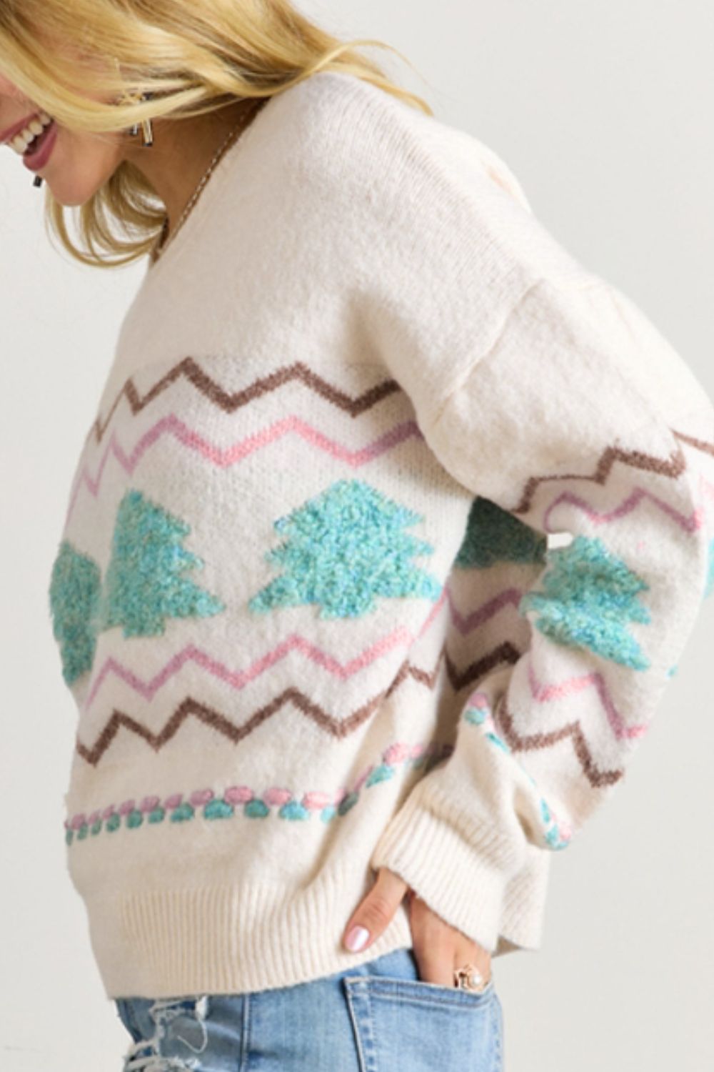 White knit sweater with textured tree motif and chevron pattern.