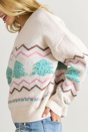 White knit sweater with textured tree motif and chevron pattern.