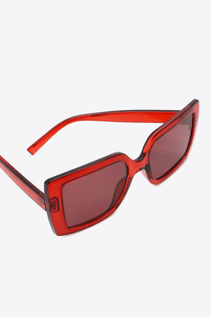 Crimson acetate rectangular sunglasses with dark lenses and bold frames.