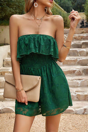 Dark green strapless romper with ruffle detail and floral embroidery.