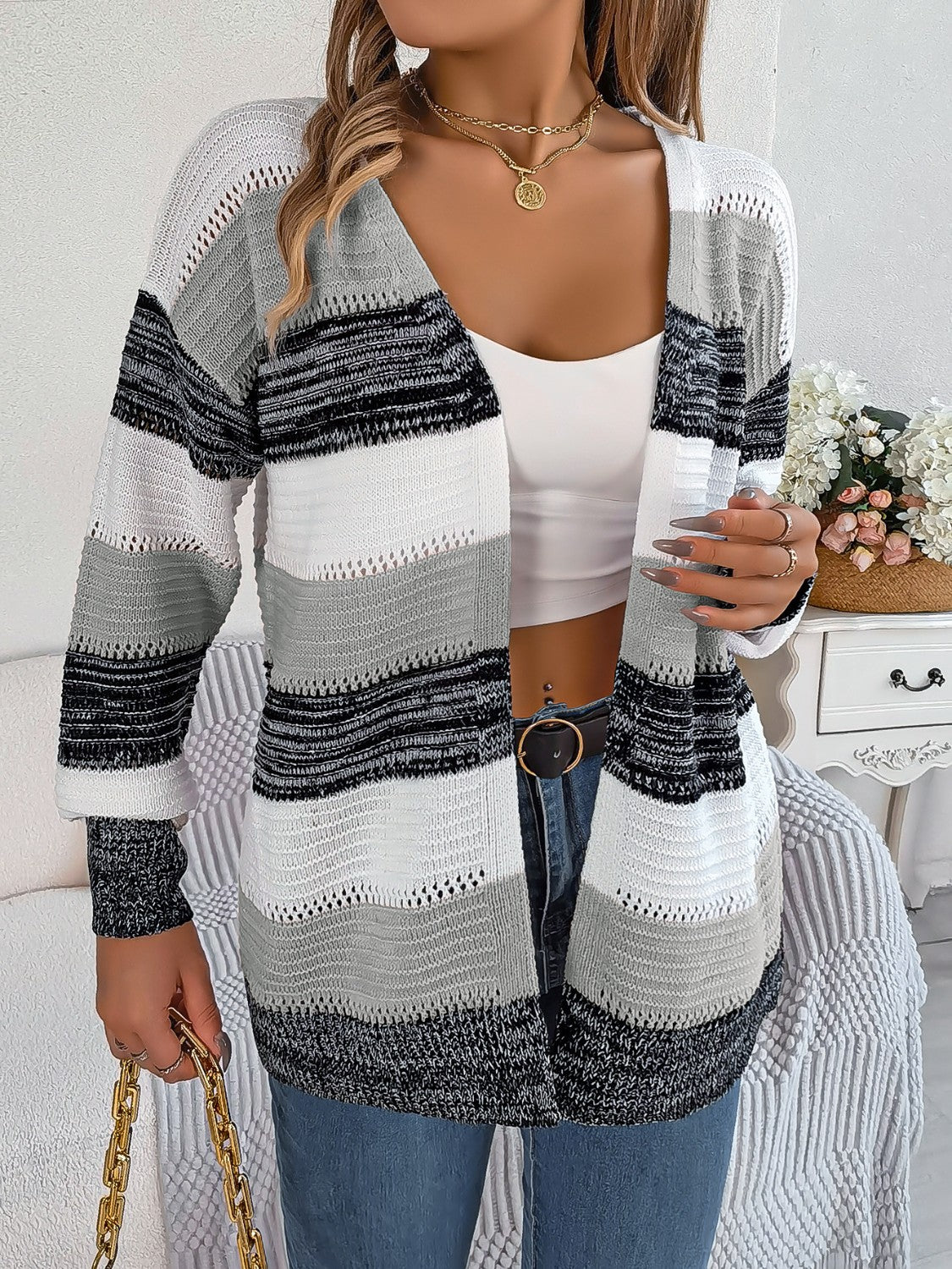 Open-front knit cardigan with horizontal stripes in grey, white, and black acrylic.