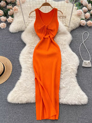Orange ribbed knit midi dress with knot-back cutout detail and V-neck.