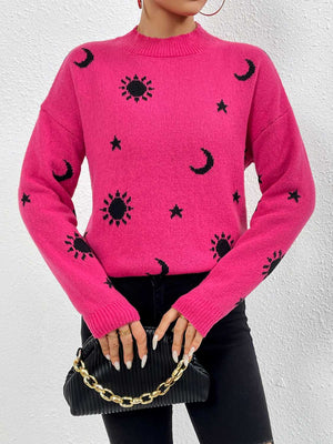 Hot pink drop shoulder knit sweater with black sun, moon, and star print.