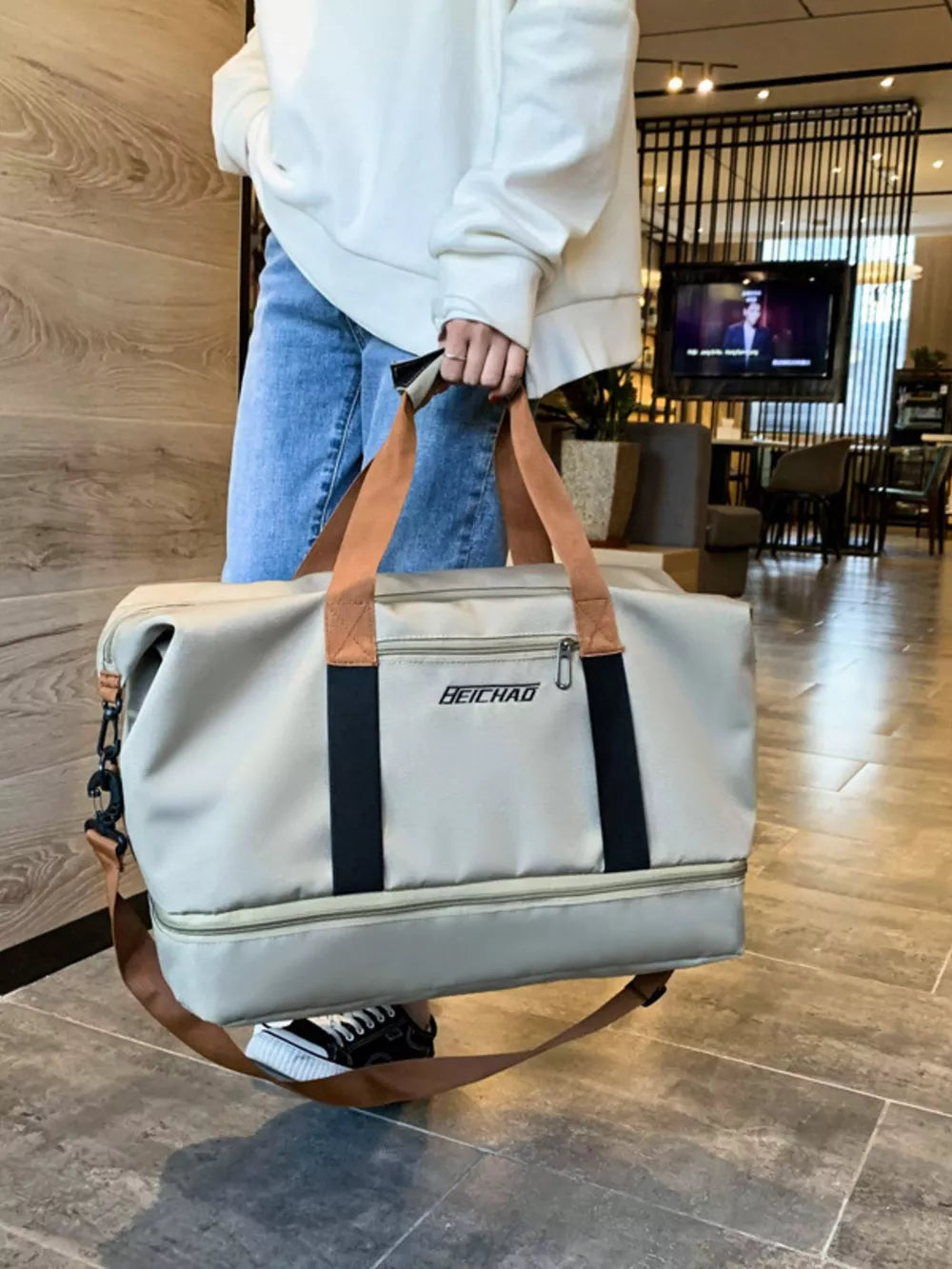 Light grey Oxford cloth travel bag with dual handles and a detachable strap.
