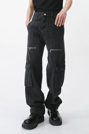 Dark denim wide-leg cargo pants with zip pockets and utility pockets.
