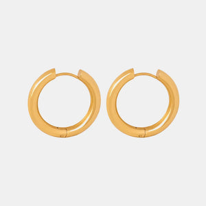 Gold hoop earrings with a sculpted, polished finish.