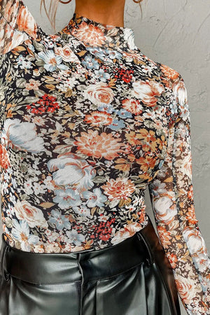Sheer floral second skin top with mock neck and long sleeves.