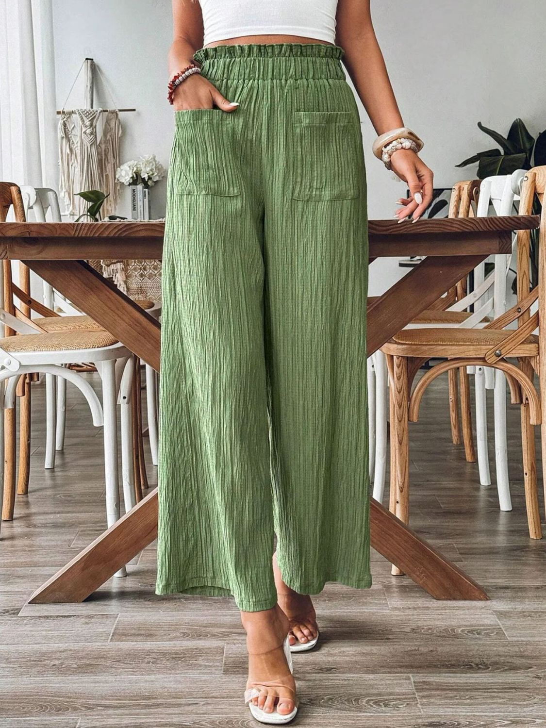 Green textured gauze palazzo trousers with elastic waist and pockets.