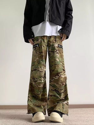 Oversized camouflage cargo pants with zipper pockets and wide legs.