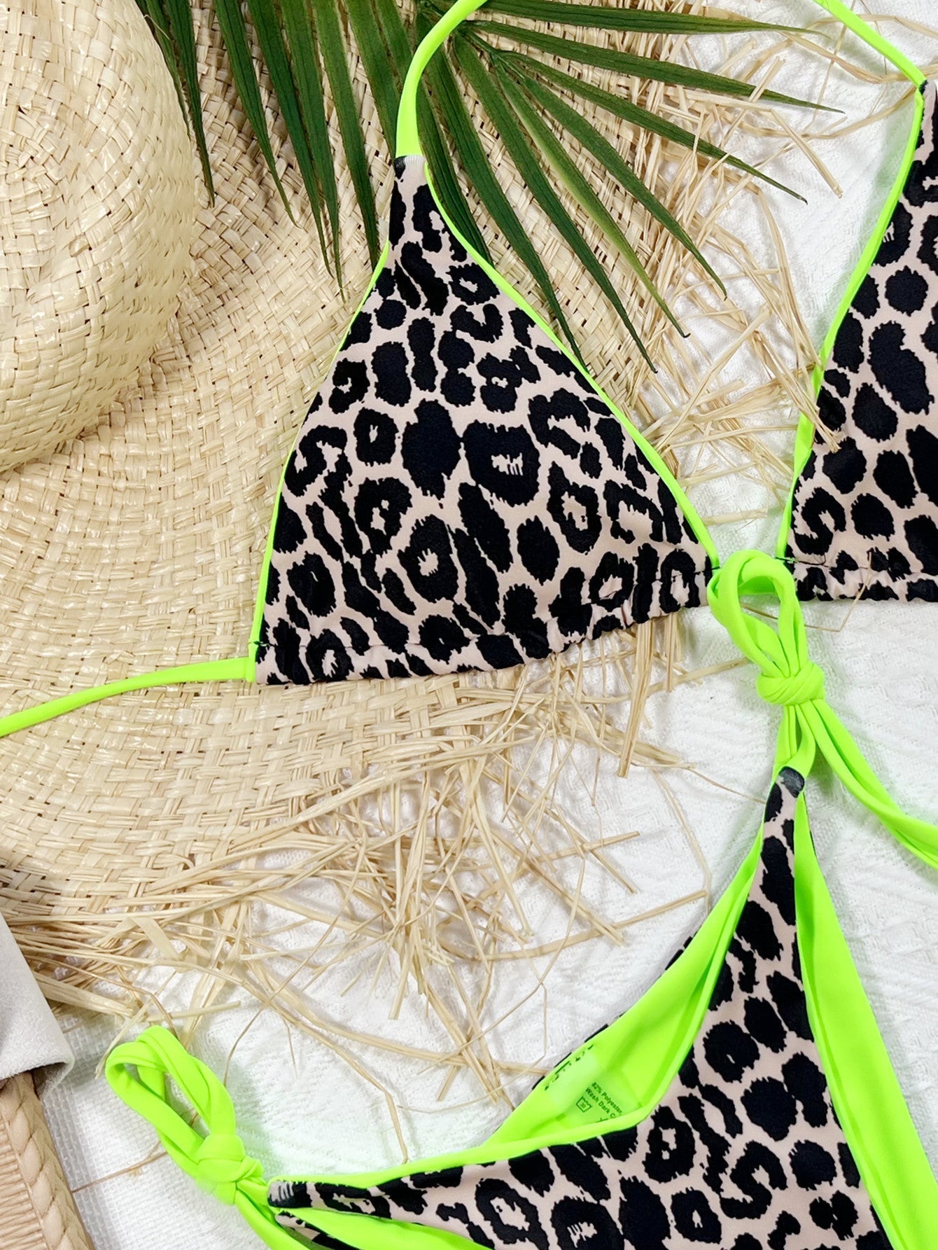 Leopard print tie-side bikini set with neon green trim and ties.