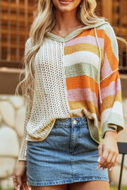 Colorblock knit hoodie with open knit beige panel and striped multi-color panel.