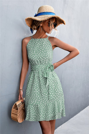 Dotted halter neck mini dress in Gum Leaf green with ruffle hem and tie waist.