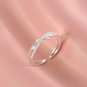 Sterling silver crossover ring with delicate pave crystal detail.