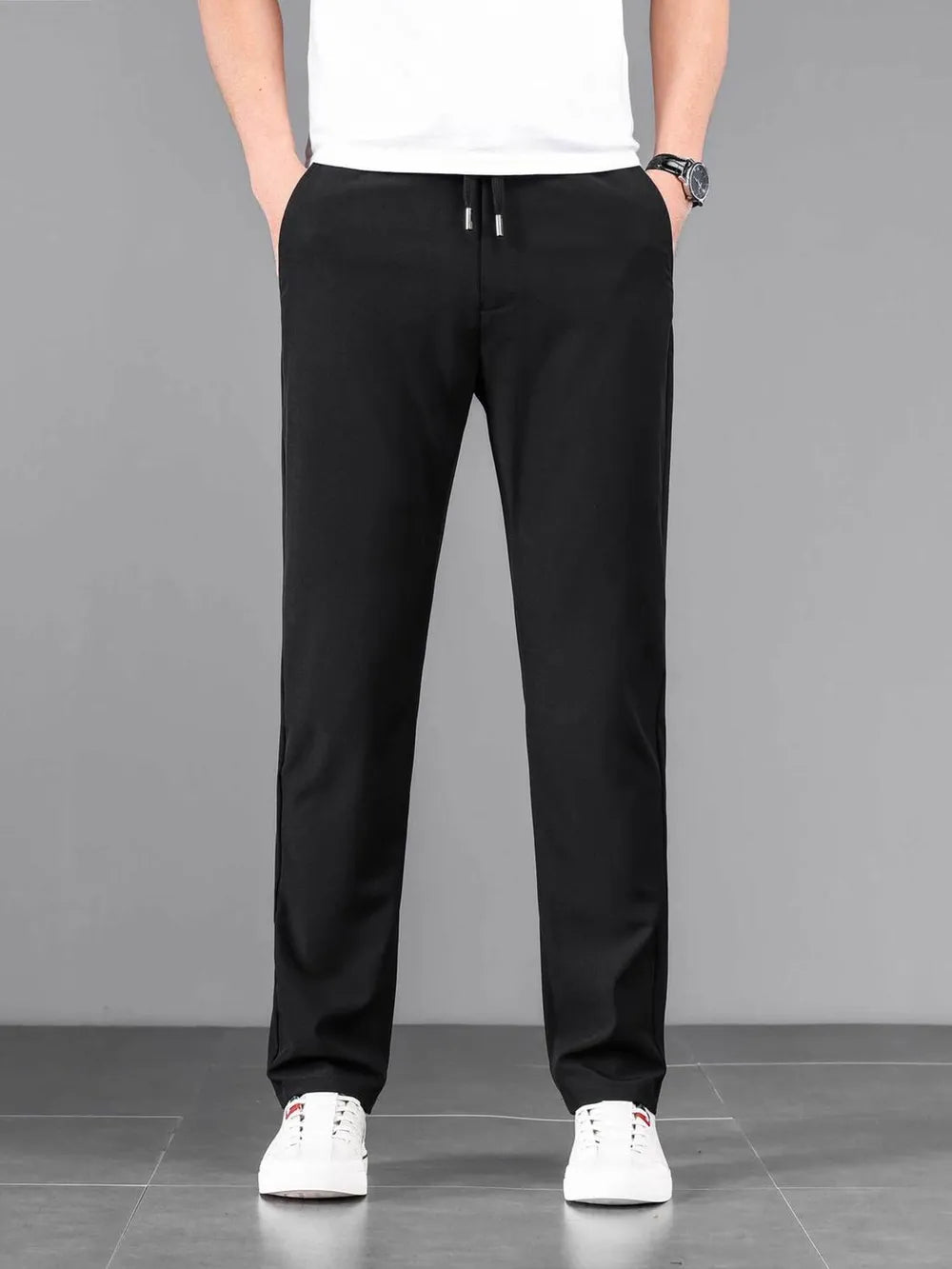 Black casual drawstring sweatpants with pockets and a relaxed fit.