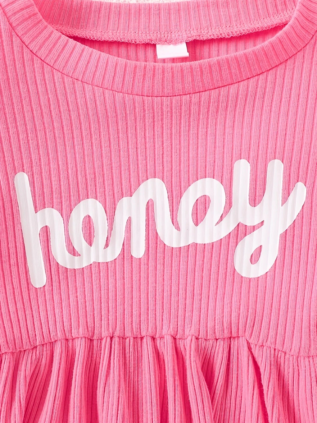 Pink ribbed baby dress with white "honey" graphic and gathered skirt