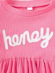 Pink ribbed baby dress with white "honey" graphic and gathered skirt