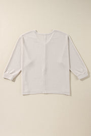 Beige waffle knit V-neck long sleeve top with cinched cuffs.