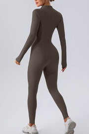 Sculpted zip-front bodycon jumpsuit in chocolate, with long sleeves and a high neckline.